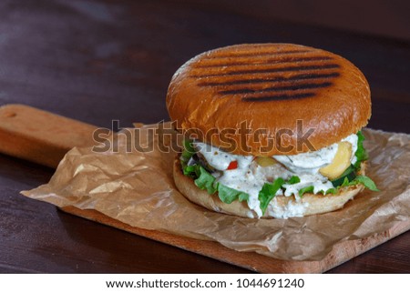 delicious chicken burger on wooden plate