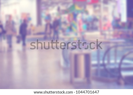 Shallow depth of field background for photo montage. Blurry shopping mall background with copy space.Ultra Violet lights.