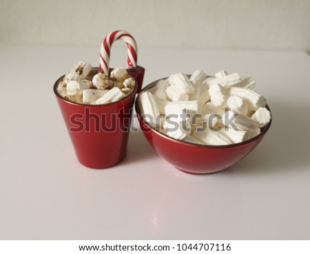 Christmas background, greeting card with a Cup of coffee or hot chocolate with marshmallows, a red plate and candy canes. Holiday photo. The mood of the expectations of celebration