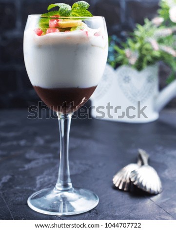 Chocolate dessert in glass with fruits.Chocolate mousse or pudding in portion glass with fresh berries