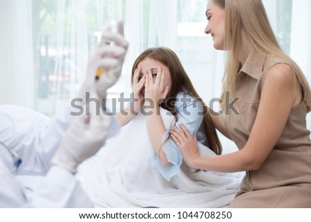 Girl scary to injection from doctor at hospital. People with medical and health care concept.