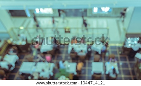 Blur abstract background of cafe or restaurant in shopping mall, top view image. Vintage style color effect.