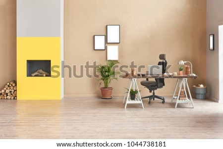 Decorative modern freelance home office style. Brown detail wall and grey sofa decoration with wood table and black chair laptop decor.
