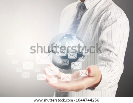 Businessman touching graphic of virtual shopping trolley icon at internet shopping application on social network website after search and select products, display on visual screen