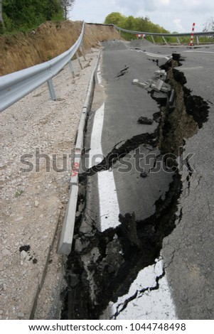 Road collapses with huge cracks. International road collapsed down after bad construction. Damaged Highway Road. Asphalt road collapsed and fallen. Erosion. Vertical