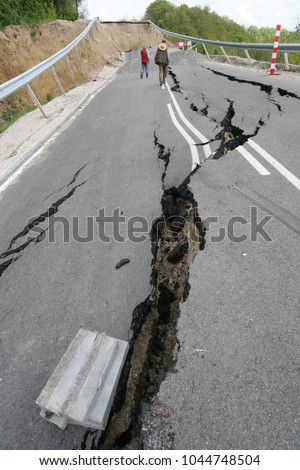 Road collapses with huge cracks. International road collapsed down after bad construction. Damaged Highway Road. Asphalt road collapsed and fallen. Erosion. Vertical