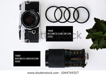 business card mockup with old film camera and lenses with filters and glasses, copy space white background