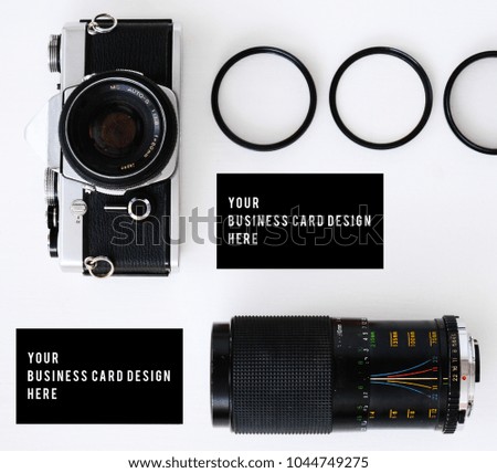 business card mockup with old film camera and lenses with filters and glasses, copy space white background