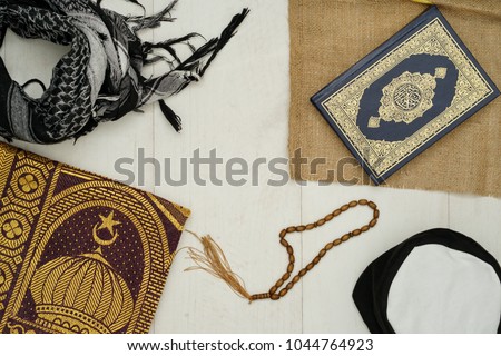 Ramadhan objects. Holy Quran, beautiful beads, prayer rugs, and moslem clothes. Royalty-Free Stock Photo #1044764923