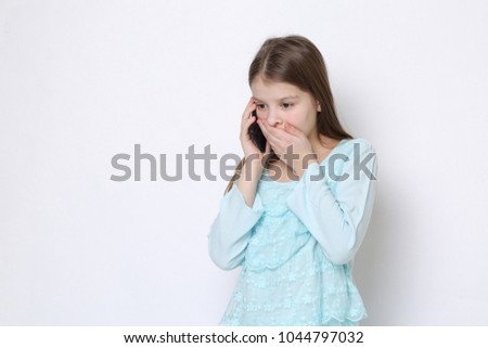 School teen girl holding mobile phone (smartphone)