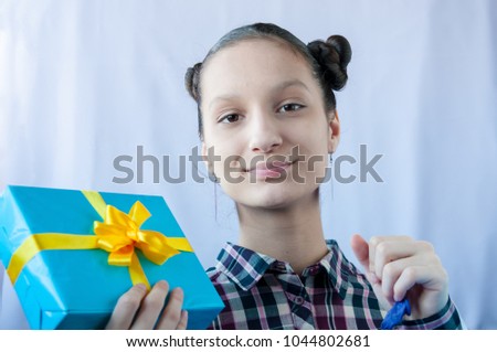 Teen girl holding a gift in her hands