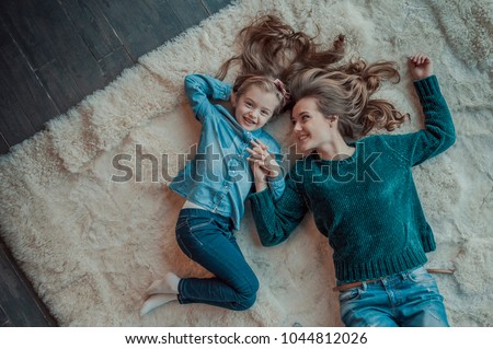 happy and smiling mom and daughter