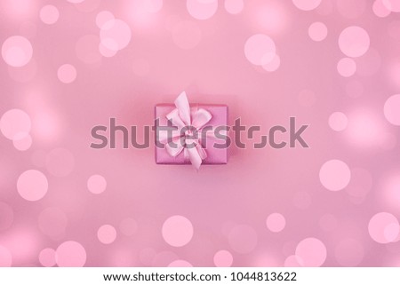 Decorative festive gift box with pink color on pink background. Flat flat top view