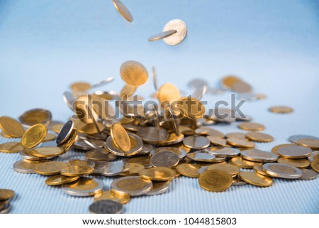 Falling coins money on blue background, business wealth concept idea.