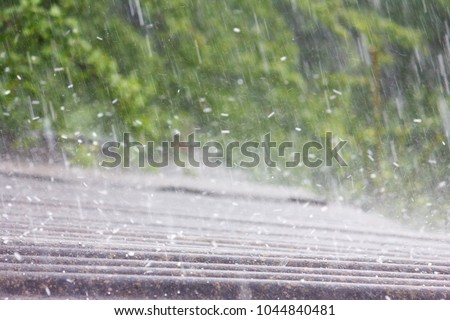 summer rain with hail falls on the roof of slate Royalty-Free Stock Photo #1044840481