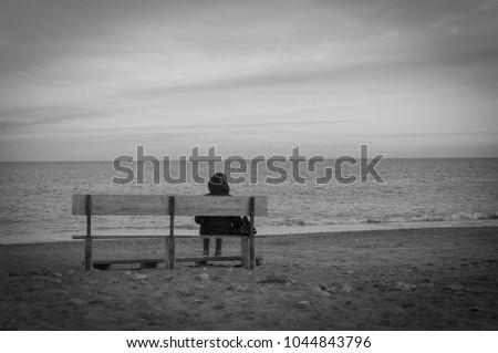 depressed and sad woman facing the sea Royalty-Free Stock Photo #1044843796