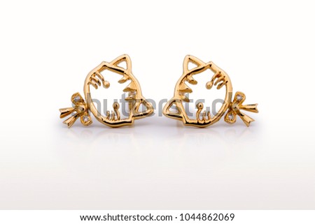 Beautiful Cute Baby & Kids earrings Jewelry with the cat design and a bow tie in yellow gold and diamond, ideal birthday baby gift isolated on white background 