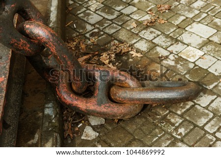 An old classical anchor chain on a sea anchor. The system and principle of the most reliable connection realized in the anchor iron chain. Large anchor chain close-up
