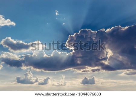 The sun behind a large cloud. rays of light.