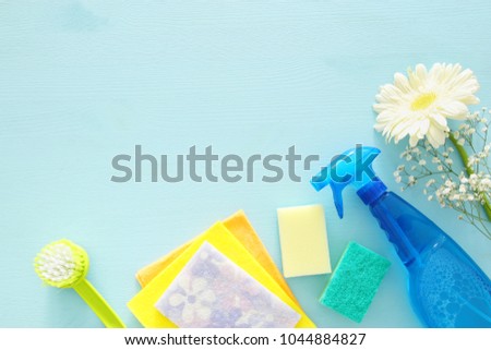 Spring cleaning concept with supplies on wooden table