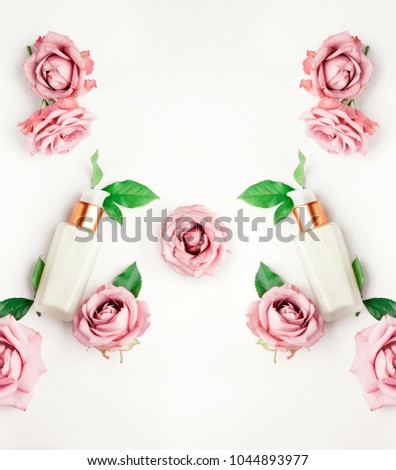 Pink roses and face cream flatlay frame with mirror effect. On white background with copy space for text