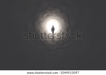 man getting out of a dark tunnel toward light Royalty-Free Stock Photo #1044915097