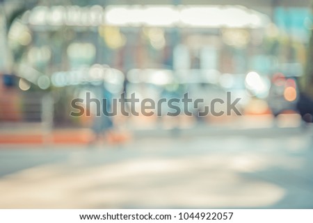 Abstract blur image of people walking on street with bokeh for background usage . (vintage tone)