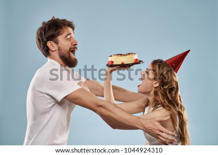 a woman throws a cake in the face of a man                             