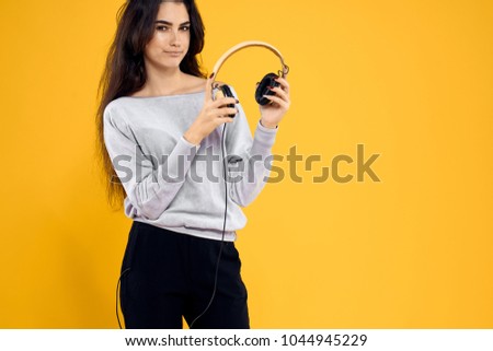 woman with headphones, music fan, fashion, convenience                              
