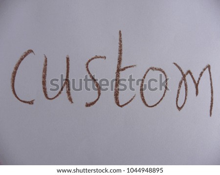 Text custom written by brown oil pastel on white color paper