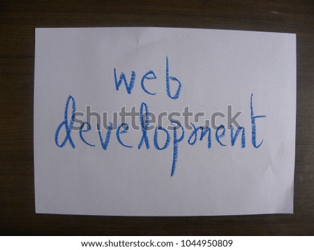 Text web development by blue oil pastel on white color paper