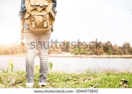 Young woman Traveler with backpack relaxing outdoor. Summer vacations and Lifestyle hiking concept. Retro filter effect, selective focus
