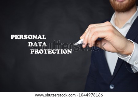 The businessman writes an inscription with a white marker:PERSONAL DATA PROTECTION