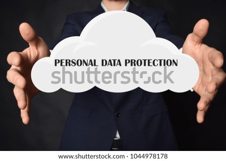 In the hands of a businessman, a cloud with the inscription:PERSONAL DATA PROTECTION
