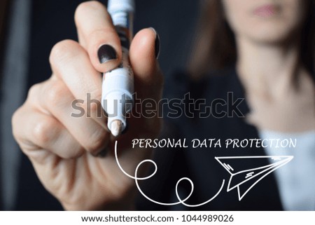 The businessman writes an inscription with a white marker:PERSONAL DATA PROTECTION