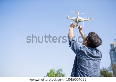 man take drone with blue sky in the park