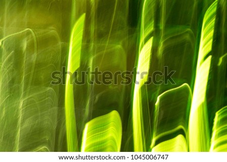Abstract background of green neon glowing light shapes. Bright stripes  Can use for poster, website, brochure, print.