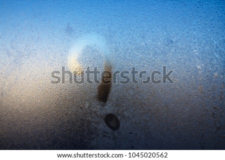 Winter frost, the inscription on the frozen glass - question mark.