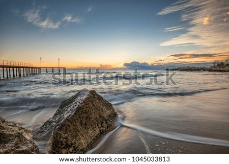 Sea wave motion blur, low angle view, a beautiful view with first rays over the sea