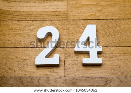 Figure twenty-four on a wooden, parquet floor as a background.