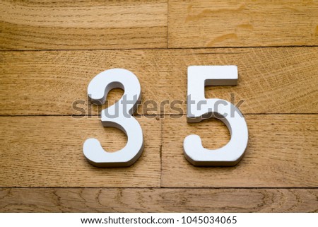 Figure thirty-five on a wooden, parquet floor as a background.