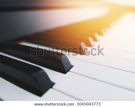 close up piano key with beautiful flare light