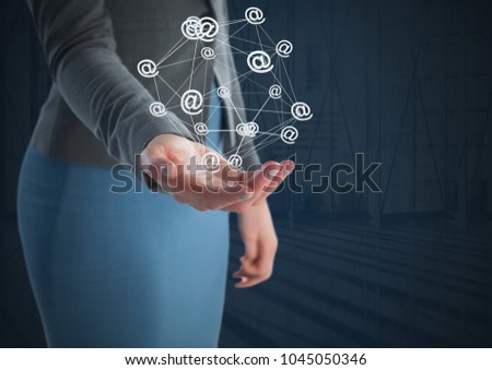 Digital composite of at sign app icons connected and Businesswoman with hand palm open and dark background
