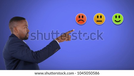 Digital composite of Man pointing at smiley faces feedback satisfaction icons