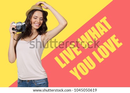 Cheerful female photographer posing for camera