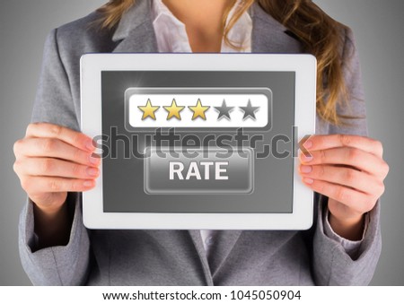 Digital composite of Hands holding tablet with review star ratings
