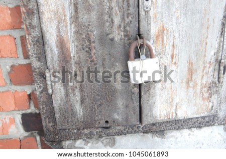 The old gray door with a lock.