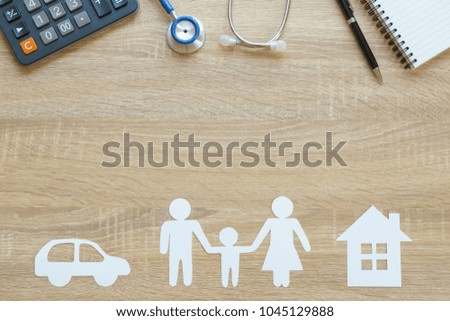 Top view of insurance concept with family, car, house paper, stethoscope and calculator