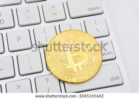 Golden Bitcoins on keyboard. Selective focus.