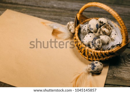 Closeup basket with eggs on sheet of paper for text lay on rustic wood background.